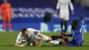 Striker Real Madrid, Karim Benzema (kiri) dan bek Chelsea, Antonio Rudiger terjatuh saat perebutan bola dalam laga leg kedua semifinal Liga Champions 2020/2021 di Stamford Bridge, London, Rabu (5/5/2021). Real Madrid kalah 0-2 dari Chelsea. (AP/Alastair Grant)