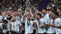 Pemain Argentina Lionel Messi memegang trofi saat dia merayakan dengan rekan satu timnya setelah memenangkan pertandingan sepak bola Finalissima antara Italia dan Argentina di Stadion Wembley, London, Inggris, 1 Juni 2022. Argentina menang 3-0. (AP Photo/Matt Dunham)