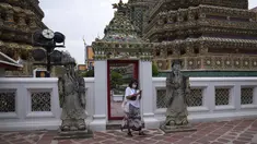 Turis yang mengenakan masker berjalan-jalan di kuil Wat Pho di Bangkok, Thailand, pada 23 Februari 2022. Thailand akan melonggarkan beberapa persyaratan masuk bagi turis asing untuk membangun kembali yang rusak akibat pandemi ekonomi. (AP Photo/Sakchai Lalit)