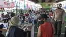 Vaksinator menyuntikkan vaksin dosis ketiga kepada seorang pria di kolong flyover Ciputat, Tangerang Selatan, Sabtu (2/4/2022). Vaksinasi booster tersebut diselenggarakan oleh Polsek Ciputat Timur dan Polres Tangerang Selatan. (merdeka.com/Arie Basuki)