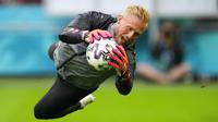 Penjaga gawang Denmark Kasper Schmeichel melompat untuk menghalau bola saat sesi latihan di Johan Cruyff Arena, Amsterdam, Belanda, Jumat (25/6/2021). Denmark akan melawan Wales pada pertandingan babak 16 besar Euro 2020. (AP Photo/Peter Dejong)