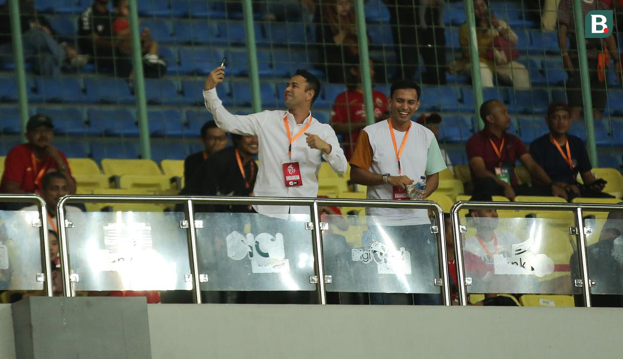 <p>Raffi Ahmad (kiri) saat menyaksikan laga pekan ke-16 BRI Liga 1 2023/2024 antara Persija Jakarta menghadapi Rans Nusantara FC di Stadion Patriot Candrabhaga, Bekasi, Minggu (22/10/2023) malam WIB. (Bola.com/Abdul Aziz)</p>