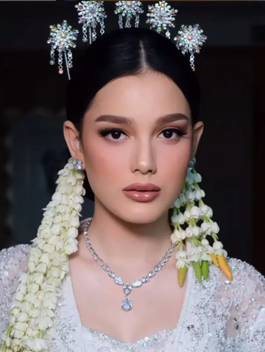 Baju pengantin yang dikenakan Yasmine Ow merupakan rancangan desainer ternama langganan para artis Indonesia yakni Ancha Wedding, sementara wajahnya dipoles oleh MUA Bennu Sorumba. Rambutnya ditata oleh hair stylish Lutfil Huda dan nail art-nya oleh Denna Henna. Tampil dengan kebaya Jawa, pesona artis blasteran Jerman – Malaysia ini semakin terpancar. (Liputan6.com/IG/@bennusorumba)
