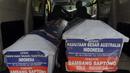 Petugas Kantor Pos mengirimkan dua peti mati ke kantor Kedutaan Besar Australia untuk Indonesia di Rasuna Said, Jakarta, Senin (9/3/2015).  Tampak, dua peti mati kiriman Bambang Saptono saat masih berada di dalam mobil. (Liputan6.com/Andrian M Tunay)