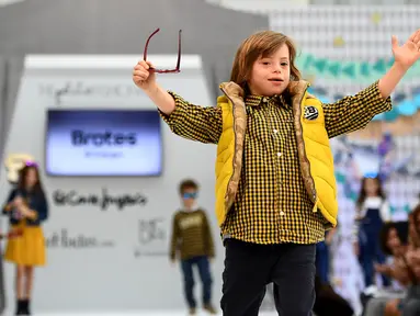 Seorang anak laki-laki dengan down syndrome ambil bagian di atas catwalk pekan mode Petite Fashion Week di Madrid, 6 Oktober 2017. Model mungil itu berasal dari Garrigou Foundation, tempat pendidikan untuk anak-anak berkebutuhan khusus (GABRIEL BOUYS/AFP)