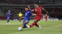 Gelandang Timnas Indonesia U-20, Toni Firmansyah (kanan) berusaha melepaskan umpan yang berusaha dihalangi bek Thailand U-20, Pakawat Teangakson pada laga uji coba internasional di Stadion Utama Gelora Bung Karno (SUGBK), Senayan, Jakarta, Jumat (26/1/2024) malam WIB. (Bola.com/M Iqbal Ichsan)