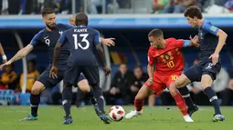 Pemain timnas Belgia, Eden Hazard berebut bola dengan pemain Prancis, Benjamin Pavard dan Prancis Olivier Giroud pada babak semifinal  di Stadion St. Petersburg, Selasa (10/7). Timnas Prancis berhasil menang 1-0 atas timnas Belgia. (AP/Natacha Pisarenko)