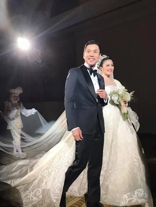 Sesuai dengan konsep pernikahannya, kue pengantin itu juga berbentuk istana Cinderella yang menjuntai tinggi ke atas dan berwarna putih. (Facebook/Ary Bakri)