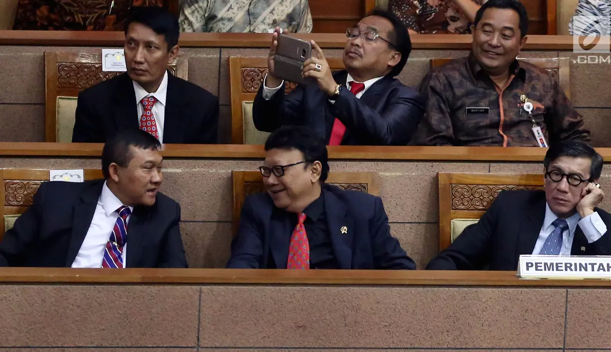 Menteri Hukum dan HAM Yasona Laouly (kanan) bersama Menteri Dalam Negeri Tjahjo Kumolo (tengah) mengikuti Rapat Paripurna di Komplek Parlemen, Senayan, Jakarta, Kamis (20/7). (Liputan6.com/Johan Tallo)