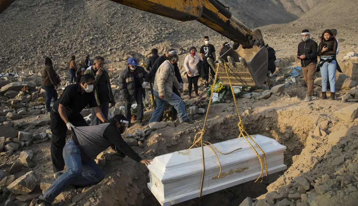Backhoe menempatkan peti mati berisi jenazah Vicenta Panduro Panduro (87) yang meninggal karena komplikasi COVID-19 saat pemakaman di Carabayllo, Lima, Peru, Selasa (25/8/2020). Total kasus COVID-19 di Peru mencapai 600 ribu dengan 407 ribu sembuh dan 27.813 wafat. (AP Photo/Rodrigo Abd)