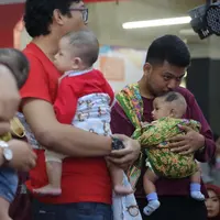 Menggendong memang identik dengan ibu, tapi siapa bilang ayah tak bisa ikut serta melakukannya? (Sumber foto: Daniel Kampua/FIMELA.com)