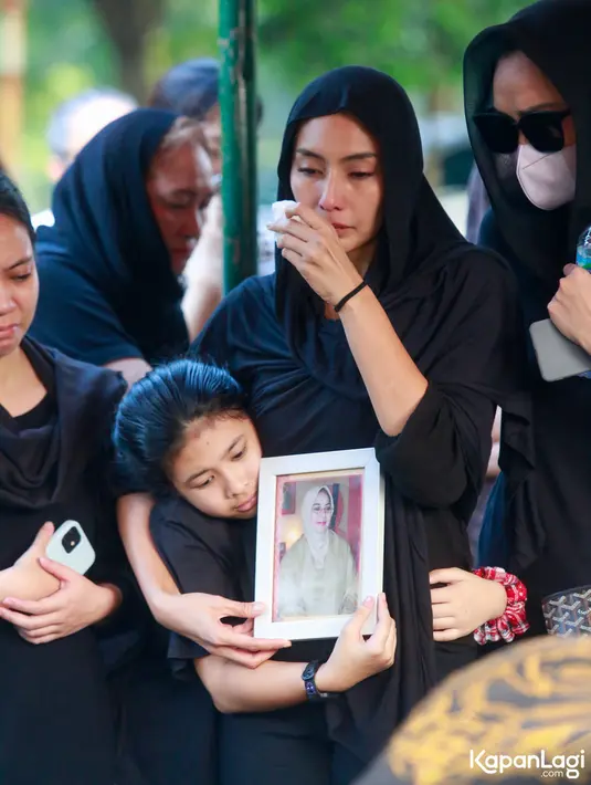 Gurat kesedihan Tyas ditinggalkan orang yang melahirkannya untuk selamanya. Setelah disalatkan masjid dekat rumah duka, ibunda Tyas di makamkan di TPU, Pondok Rangon, Jakarta Timur. [Foto: Muhammad Akrom Sukarya/KapanLagi.com]