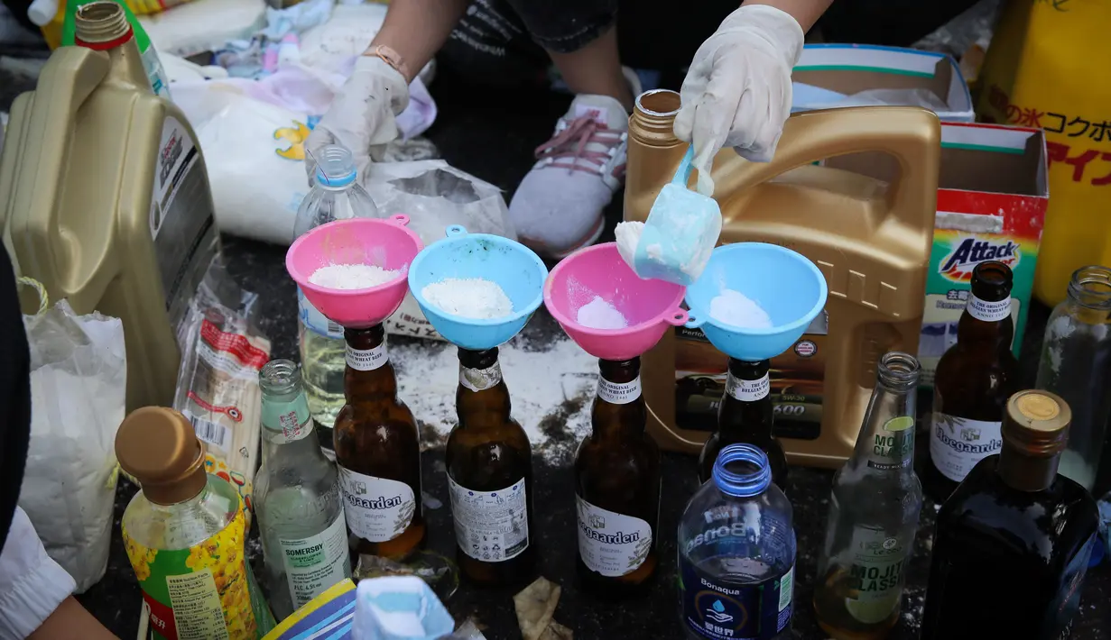 Pelajar membuat bom molotov di Chinese University, Hong Kong, Rabu (13/11/2019). Gerakan antipemerintah Hong Kong yang telah berlangsung selama lima bulan bertindak semakin keras. (AP Photo/Kin Cheung)