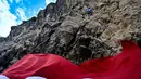 Seorang pemanjat menaiki  tebing saat pemasangan bendera merah putih pada tebing di Lhoknga, Aceh, Kamis,  13 Agustus 2026.