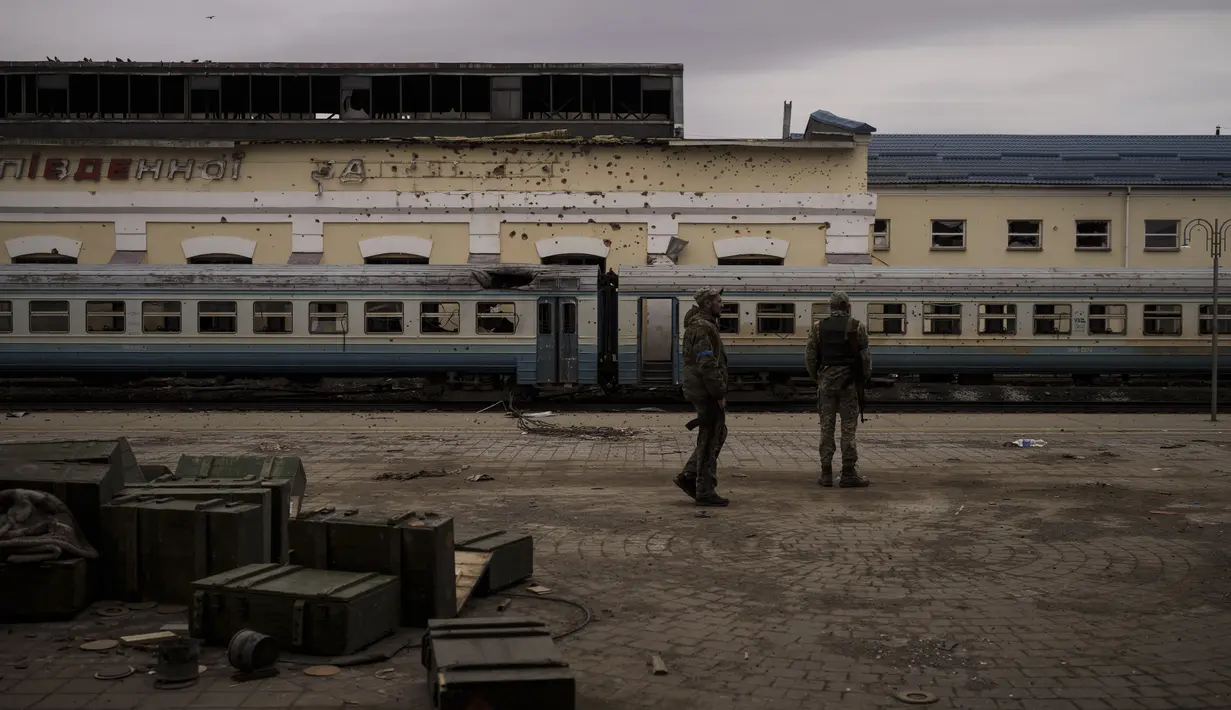 Prajurit Ukraina berjalan di stasiun kereta api yang rusak di kota Trostsyanets, Ukraina, Senin, 28 Maret 2022. Trostsyanets baru-baru ini direbut kembali oleh pasukan Ukraina setelah dikuasai oleh Rusia sejak awal perang. (AP Photo/Felipe Dana)