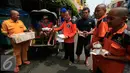 Juru parkir membagikan nasi bungkus kepada warga di jalan Malioboro,Yogyakarta, Jumat (11/3). Dalam aksinya mereka meminta dukungan kepada pengguna jalan yang melintas dan menuntut kejelasan relokasi yang bernurani. (Liputan6.com/Boy Harjanto)