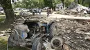 Sebuah traktor duduk di antara puing-puing di Waverly, Tennessee, Rabu (25/8/2021). Hujan deras selama akhir pekan menyebabkan banjir di Tennessee Tengah dan telah mengakibatkan puluhan orang tewas karena rumah dan jalan pedesaan hanyut. (AP Photo/Mark Humphrey)