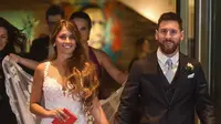 Bintang sepak bola, Lionel Messi berjalan di karpet merah bersama istrinya Antonella Roccuzzo di Rosario, provinsi Santa Fe, Argentina (30/6). Messi menikahi Antonella yang dikenalnya sejak usia 5 tahun. (AFP Photo/Eitan Abramovich)