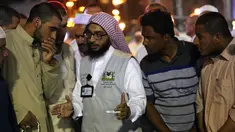 Jemaah haji berbincang dengan seorang penerjemah di kota suci Islam, Makkah, 17 Agustus 2018. Pemerintah Arab Saudi mengerahkan para penerjemah dari berbagai bahasa yang bekerja 24 jam per hari untuk membantu para jemaah. (AFP/AHMAD AL-RUBAYE)