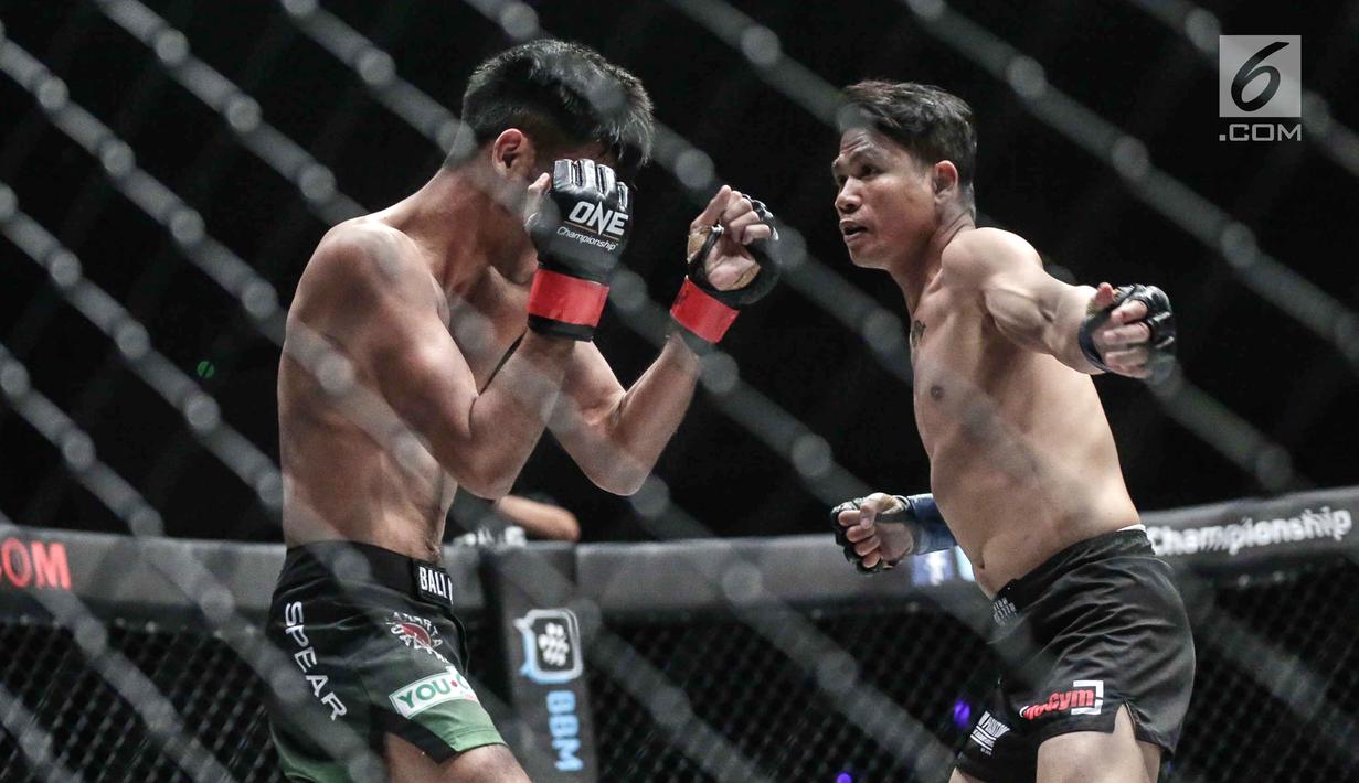Dua petarung Indonesia, Rizki Umar (kiri) menahan pukulan petarung Arnol Batubara (kanan) saat berlaga pada seri pertama dalam One Championship di Jakarta, Sabtu (20/1). Riski Umar langsung mengajak Arnol bermain keras. (Liputan6.com/Faizal Fanani)
