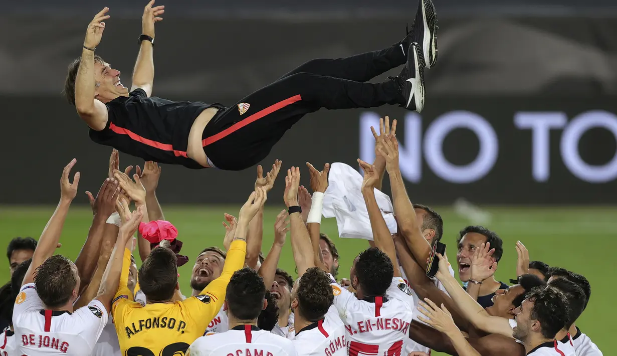 Pemain Sevilla mengangkat sang pelatih, Julen Lopetegui, usai mengalahkan Inter Milan pada laga final Liga Europa 2019/2020 di Stadion RheinEenergie, Sabtu (22/8/2020) dini hari WIB. Sevilla menang 3-2 atas Inter Milan. (AFP/Friedemann Vogel/pool)