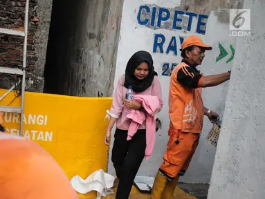 Petugas PPSU menyelesaikan pengerjaan jalur peningkatan aksesibilitas jalan lokal dan kampung menuju Stasiun MRT di Gang Teladan, Cipete Raya, Jakarta, Senin (2/9/2019). Hal ini untuk meningkatkan keamanan bagi pejalan kaki dan pesepeda menuju Stasiun MRT Cipete Raya. (Liputan6.com/Faizal Fanani)