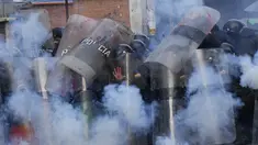 Kembang api yang dilemparkan pengunjuk rasa meledak di dekat formasi polisi saat terjadi bentrokan di dekat Kementerian Pendidikan di La Paz, Bolivia, Kamis, 13 April 2023. (AP Photo/Juan Karita)