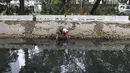 Petugas Animal Rescue berusaha menyelamatkan seekor anjing yang terjebak di gorong-gorong kali Gresik, Menteng, Jakarta Pusat, Rabu (23/5). Anjing ini terjebak selama 3 hari dan dibawa ke tempat penampungan. (Liputan6.com/Arya Manggala)