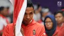 Pelari muda Indonesia, M Zohri melakukan prosesi mencium bendera Merah Putih saat upacara pengukuhan di Istora Senayan, Jakarta, Minggu (5/8). Upacara dipimpin Menko PMK Puan Maharani. (Liputan6.com/Helmi Fithriansyah)