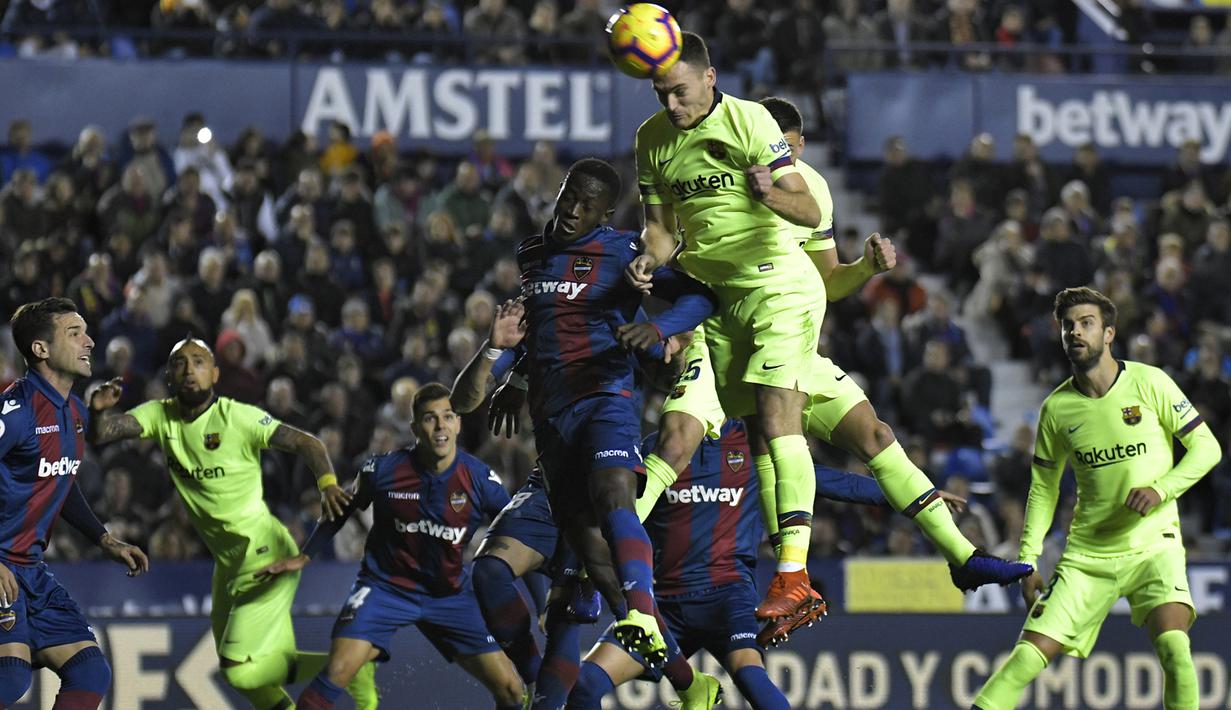 Striker Levante, Emmanuel Boateng, duel udara dengan bek Barcelona, Thomas Vermaelen, pada laga La Liga di Stadion Ciutat de Valencia, Valencia, Minggu (16/12). Levante kalah 0-5 dari Barcelona. (AFP/Jose Jordan)