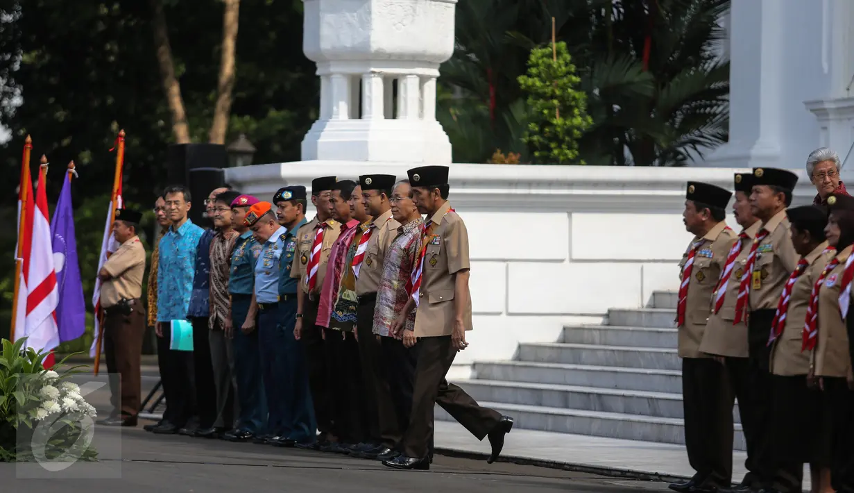 Presiden Jokowi (tengah) saat bersiap melepas kepergian anggota delegasi Gerakan Pramuka Indonesia, Jakarta, Jumat (24/7). 462 kontingen Pramuka Indonesia akan berkiprah di Jambore Dunia ke-23 di Kirarahama, Yamaguchi, Jepang. (Liputan6.com/Faizal Fanani)