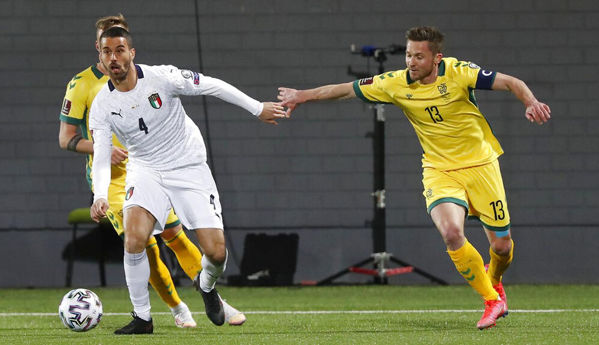 Pemain Italia Leonardo Spinazzola (kiri) memperebutkan bola dengan pemain Lithuania Saulius Mikoliunas pada pertandingan Grup C kualifikasi Piala Dunia 2022 di Stadion LFF, Vilnius, Lithuania, Rabu (31/3/2021). Italia menang 2-0. (AP Photo/Mindaugas Kulbis)