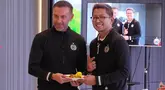 Presiden Persija, Mohamad Prapanca memberikan tumpeng kepada pelatih Thomas Doll saat merayakan Hari Ulang Tahun Persija Jakarta ke-95 di Cinepolis Senayan Park, Jakarta, Selasa (28/11/2023). (Bola.com/Adine)