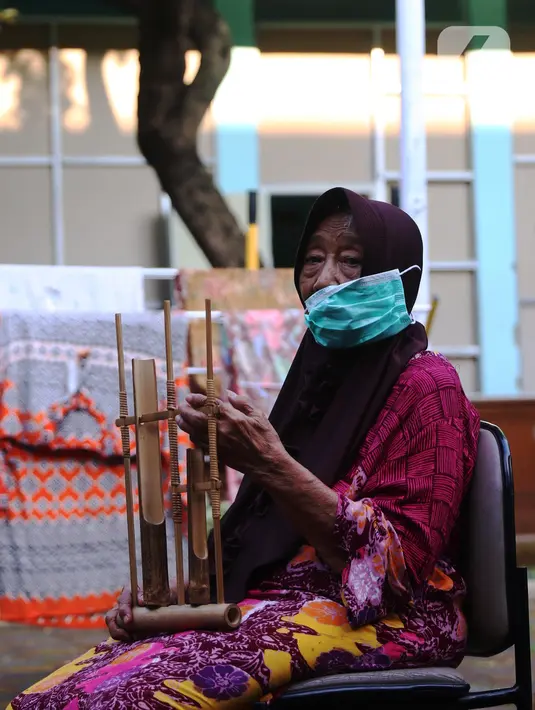 Seorang lansia mengikuti latihan angklung di Rumah Rehabilitasi Psikososial Dinas Sosial Kota Tangerang, Banten, Rabu (19/5/2021). Kegiatan berlatih angklung bagi lansia tersebut guna mengisi waktu luang sekaligus melatih motorik, auditori, dan sensorik para lansia. (Liputan6.com/Angga Yuniar)