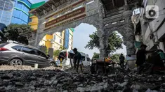 Pekerja saat mengerjakan perbaikan trotoar di Pasar Petak Sembilan, Glodok, Jakarta, Rabu (19/7/2023). (Liputan6.com/Johan Tallo)