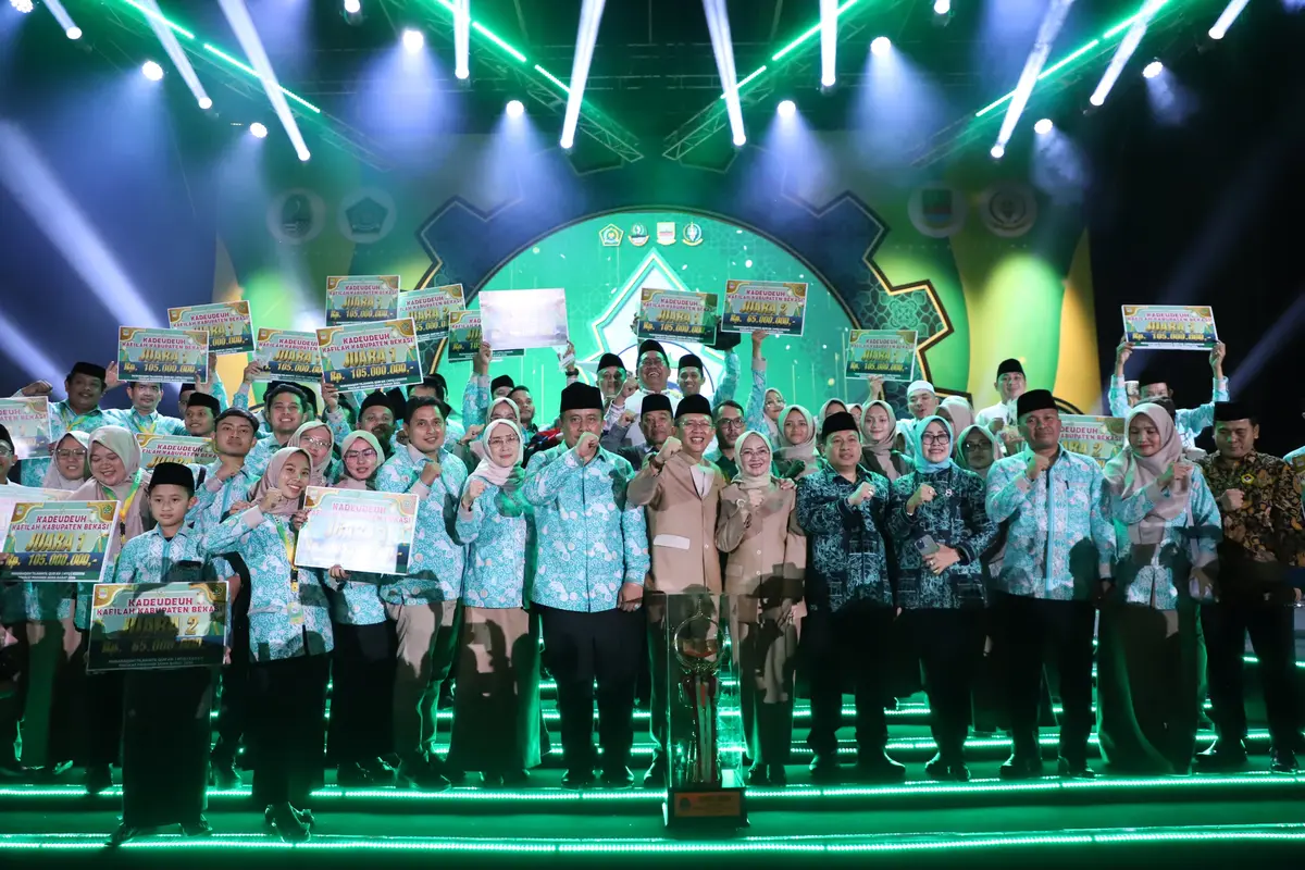 Pj Bupati Bekasi Dani Ramdan menerima trophy bergilir Juara Umum MTQ ke-38 tingkat Jawa Barat, dari Sekda Jabar, Herman Suryatman, di Plaza Pemkab Bekasi