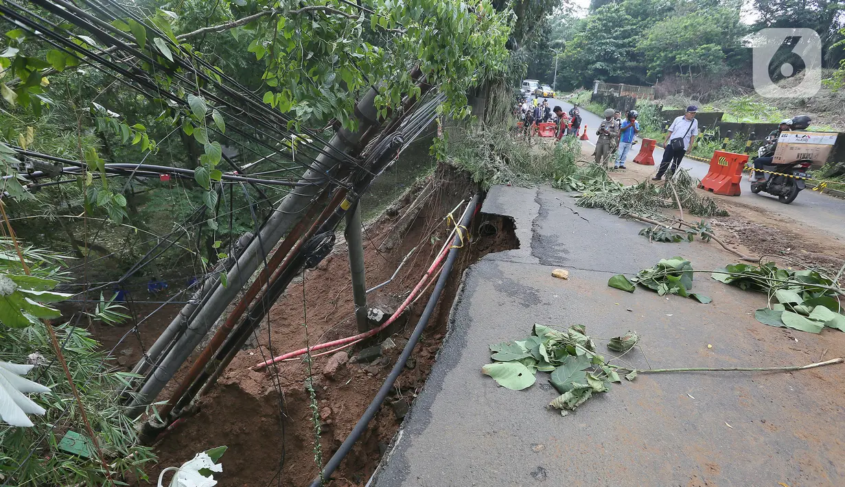 Kondisi lalu lintas dekat longsor di kawasan Jembatan Darul Qur’an, Jalan KH. Tb. M. Falak, Kecamatan Bogor Barat, Kota Bogor, Jawa Barat, Rabu (12/10/2022). Longsor yang terjadi pada kemarin sore saat hujan deras menyebabkan jalan utama yang menghubungkan Jalan Semeru dengan Jalan Raya Loji-Gunung Batu kini hanya dapat dilalui sepeda motor. (merdeka.com/Arie Basuki)