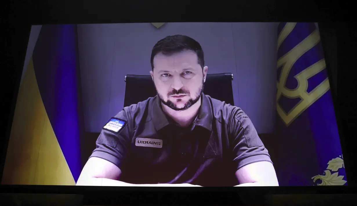 Presiden Ukraina Volodymyr Zelensky menyampaikan pidato lewat video yang disetel saat upacara pembukaan Festival Film Cannes edisi ke-75 di Cannes, Prancis selatan, Selasa (17/5/2022). Zelensky menyinggung kembali kekuatan sinema dan bioskop saat Perang Dunia II silam. Khususnya film Charlie Chaplin 1940 bertajuk The Great Dictator yang mengejek Adolf Hitler.  (Photo by Vianney Le Caer/Invision/AP)