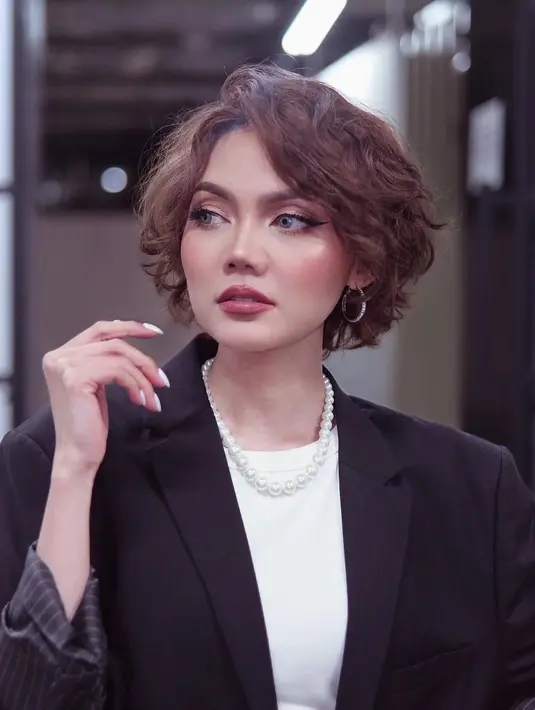 Tampilan makeup memesona lainnya dari Rina Nose. Kali ini, Rina Nose bereksperimen dengan warna yang lebih pop, yaitu nuansa keunguan yang ternyata pas di wajahnya. [Foto: Instagram/rinanose16]