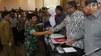 Panglima TNI Marsekal Hadi Tjahjanto (kiri) bersalaman dengan Ketua DPD RI Oesman Sapta Odang (OSO) saat raker dengan Komite I DPD RI di kompleks parlemen, Jakarta, Selasa (7/5/2019). OSO mengapresiasi pelaksanaan Pemilu 2019 yang dinilai berlangsung aman dan tertib. (Liputan6.com/JohanTallo)
