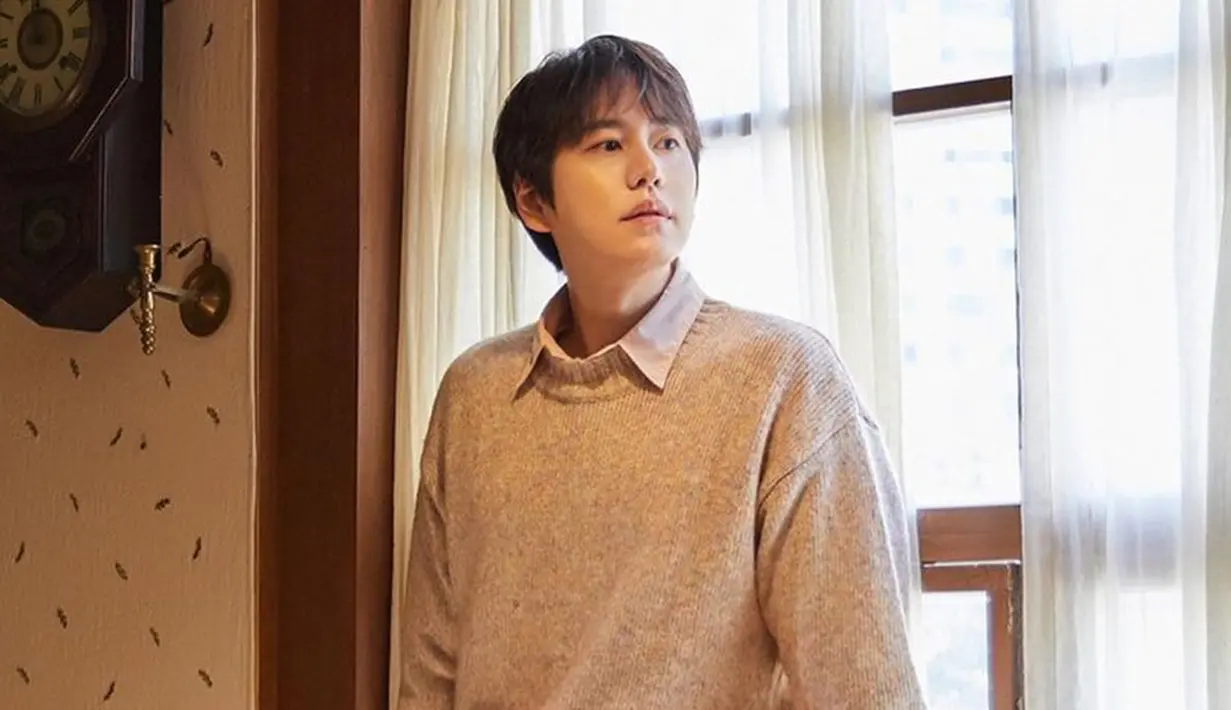 <p>Kyuhyun tampil kece menggunakan sweater yang dipasangkan dengan kemeja berwarna putih. Penampilannya makin keren menggunakan jeans berwarna biru. (Instagram/@gyuram88)</p>