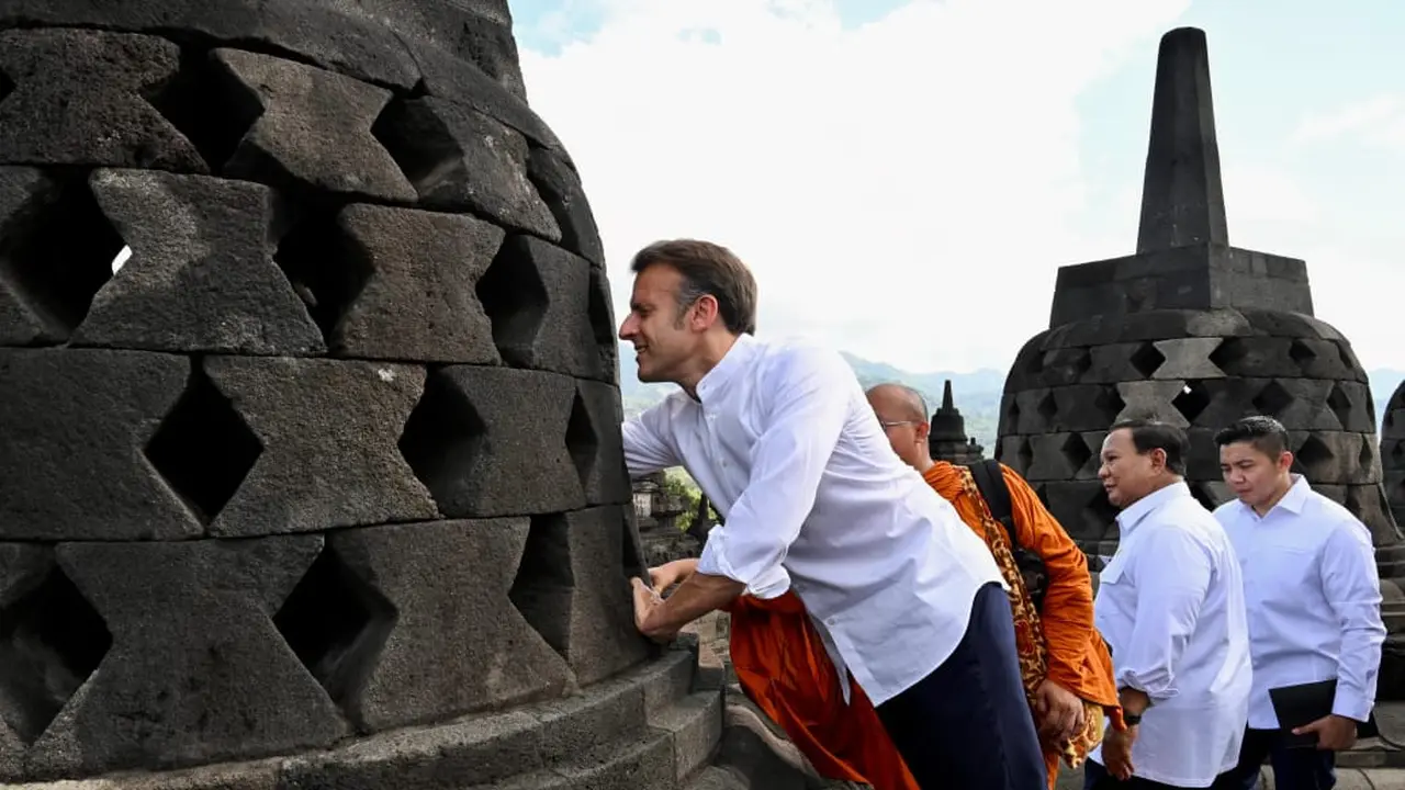 Presiden Macron dan istrinya juga berusaha menggapai patung Buddha yang ada di dalam salah satu stupa di Candi Borobudur.
