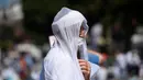 Jemaah mengenakan masker untuk menghindari penyebaran COVID-19 saat menunggu di distrik bersejarah Sultanahmet, dekat Hagia Sophia, Istanbul, Turki, Jumat (24/7/2020). Umat muslim melaksanakan salat Jumat pertama di Hagia Sophia dalam 86 tahun terakhir. (AP Photo/Yasin Akgul)