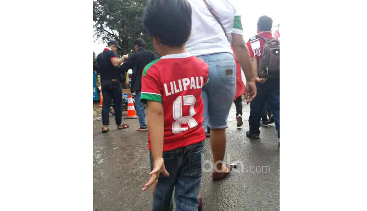 Fans cilik mengenakan Jersey pemain Timnas Indonesia, Stefano Lilipaly menuju stadion Pakansari, Bogor, (03/11/2016). (Bola.com/Darojatun)