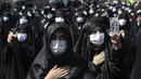 Umat Syiah mengenakan masker saat memperingati Hari Asyura di Teheran, Iran, Minggu (30/8/2020). Ritual untuk memperingati wafatnya Imam Hussein tersebut digelar dengan menerapkan jarak sosial dan mewajibkan penggunaan masker. (AP Photo/Ebrahim Noroozi)