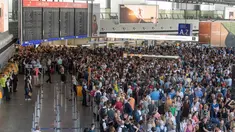 Para calon penumpang menunggu kejelasan penerbangan mereka di aula terminal 1 Bandara Frankfurt, Jerman, Selasa (7/8). Sejumlah penerbangan harus dibatalkan setelah seorang yang tidak dikenal menyusup melewati pos pemeriksaan. (Boris Roessler/dpa via AP)