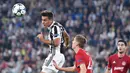 Aksi pemain Juventus, Paulo Dybala (kiri) menyundul bola melewati adangan pemain Olympiakos pada laga grup D Liga Champions di Allianz stadium, Turin, (27/9/2017). Juventus menang 2-0. (Alessandro Di Marco/ANSA via AP)