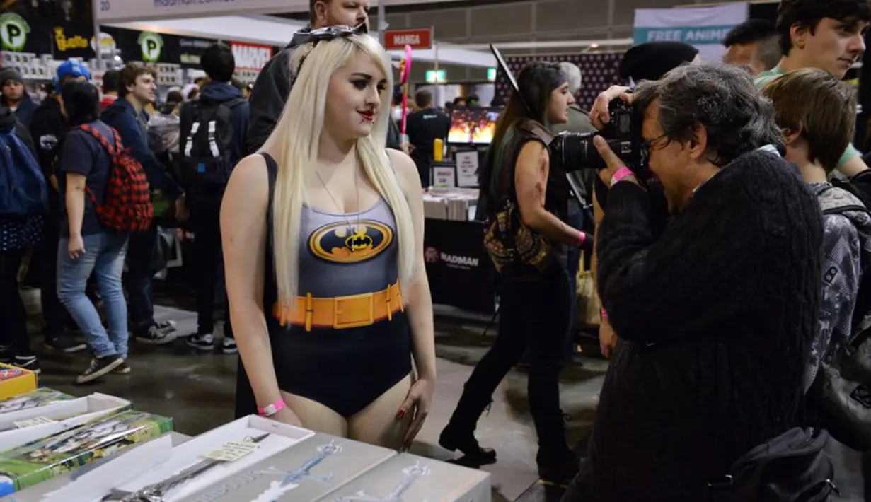 Seorang fotografer mengambil foto wanita berkostum Batman di festival yang berlangsung dari 13-15 Juni di Arena pameran Sydney, Minggu (15/6/14). (AFP PHOTO/Peter Parks)