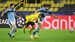 Gelandang Borussia Dortmund, Giovanni Reyna (tengah), berebut bola dengan bek Lazio, Francesco Acerbi (kanan) dalam laga lanjutan Liga Champions 2020/21 Grup F di Signal Iduna Park Stadium, Dortmund, Rabu (2/12/2020) waktu setempat. Dortmund bermain imbang 1-1 dengan Lazio. (AFP/Ina Fassbender)