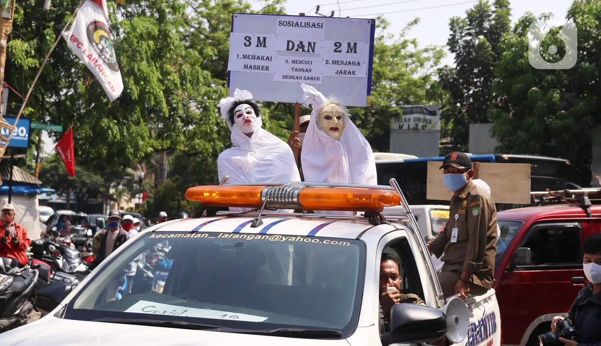 Petugas Kecamatan Larangan berkeliling mengenakan pakaian pocong saat melakukan sosialisasi di Pasar Cipadu, Kota Tangerang, Rabu (16/9/2020). Sosialisasi dengan pocong tersebut dilakukan agar masyaraka dapat memahami bahaya COVID-19. (Liputan6.com/Angga Yuniar)